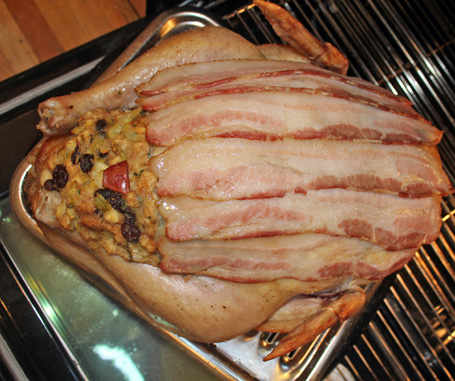 Adding bacon strips to 20# stuffed turkey about one hour into roasting