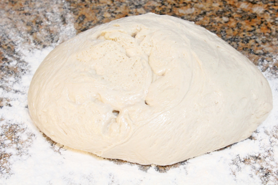 Plop the dough onto a floured surface on the counter.