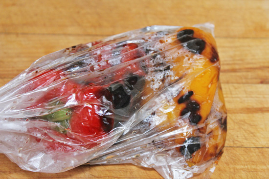 Peppers are roasting in a plastic bag. Keep them in the bag for 5 minutes or longer. 